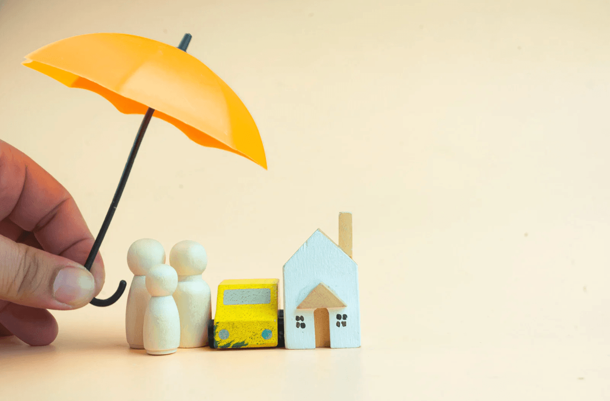 Insurance protection concept with umbrella shielding family, car and home